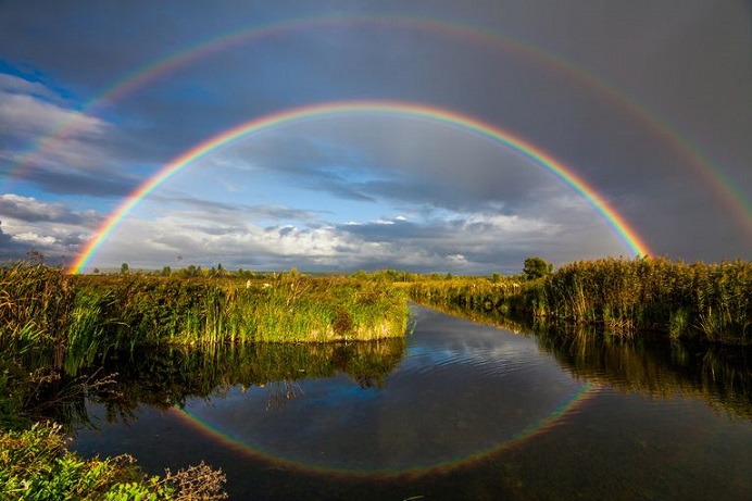 double-rainbow-over-the-river-royalty-free-image-612467020-1545041193